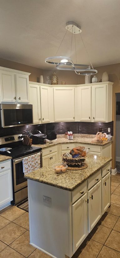Complete kitchen remodel Modern kitchen with white cabinets, granite countertops, and stainless steel appliances.